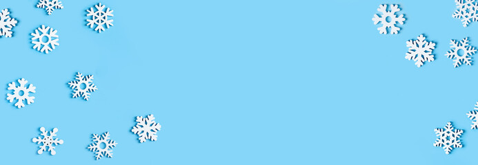 Cerulean colour year 2021.Blue Christmas background with white wodden snowflakes. Flat lay banner, poster with copy space. New year, winter mood. Mickup. Greeting card, header, website. Minimal