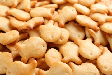 Delicious goldfish crackers as background, closeup view