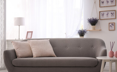 Stylish sofa in beautiful living room interior