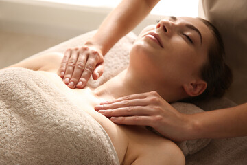 Young woman receiving body massage in spa salon