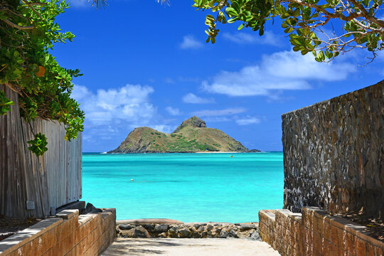 Tropical view of turquoise waters, blue sky and view of Mokuluas at Lanikai on Oahu, Hawaii. 
