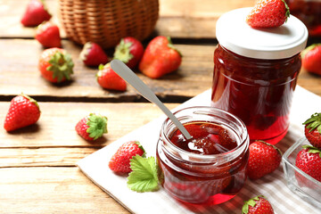 Delicious pickled strawberry jam and fresh berries on wooden table