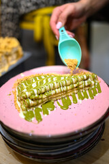 
caloric pancakes with green topping and hazelnuts. beautifully decorated pancakes with a scoop of ice cream