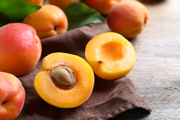 Naklejka na ściany i meble Delicious fresh ripe apricots on wooden table