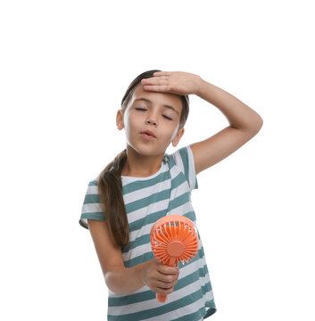 Little girl with portable fan suffering from heat on white background. Summer season
