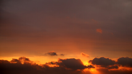 Fototapeta na wymiar Dramatic clouds lit by the setting sun.