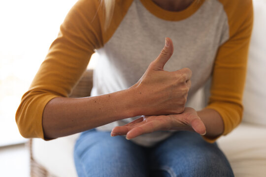 Midsection of woman making hand gesture