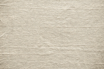 Wrinkled light beige fabric texture background