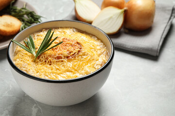 Tasty homemade french onion soup served on grey marble table
