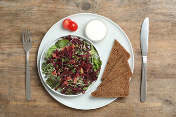 Delicious carrot salad served on wooden table, flat lay