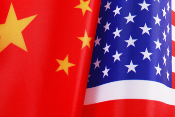 USA and China flags as background, top view. International relations