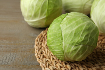 Ripe white cabbage on wooden table, closeup