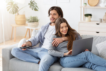 Relaxed young married couple spending weekend at home