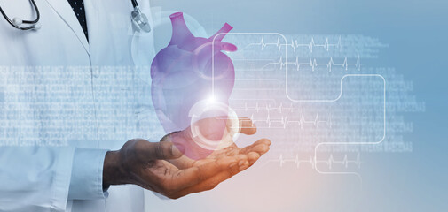 Futuristic medicine and future cardiology technology. Doctor in white coat holding heart with...