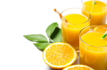 Glasses of orange juice and fresh fruits on white background, closeup