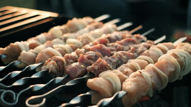 Shish kebab coocking on sticks fried on coals. 4k footage