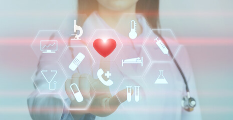 Female doctor choosing heart button on interactive board