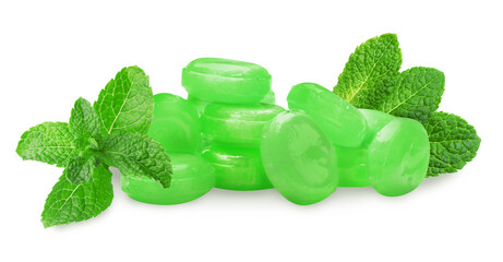 Mint hard candies and green leaves on white background