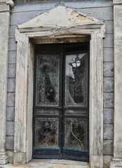 Crypt Door with Marble Frame and Glass Windows and Cobwebs