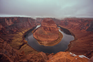 Horseshoe Bend on Colorado River at dawn in cloudy weather. Panoramic view of horseshoe bend
