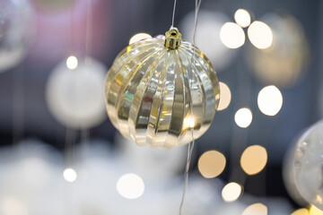 Closeup of Christmas tree gold ball decorations.