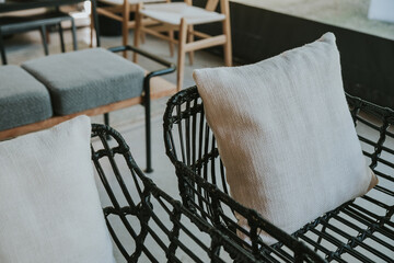 black wicker chairs with white pillows.
