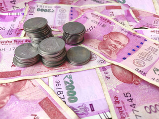 bank note and coins , indian 2000 rs currency with stack of coins full Background