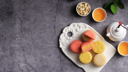 Colorful Snow Skin Moon Cake, Sweet Snowy Mooncake, Traditional Savory Dessert for Mid-Autumn Festival on Stone Background, Close up, Lifestyle. Copy Space for text