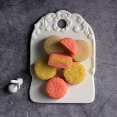 Colorful Snow Skin Moon Cake, Sweet Snowy Mooncake, Traditional Savory Dessert for Mid-Autumn Festival on Stone Background, Close up, Lifestyle.