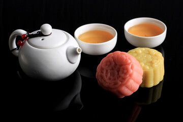 Colorful Snow Skin Moon Cake, Sweet Snowy Mooncake, Traditional Savory Dessert for Mid-Autumn Festival on Black Background, Selected Focus