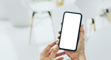 cell phone mockup blank white screen.woman hand holding texting using mobile on desk at coffee shop.background empty space for advertise.work people contact marketing business,technology