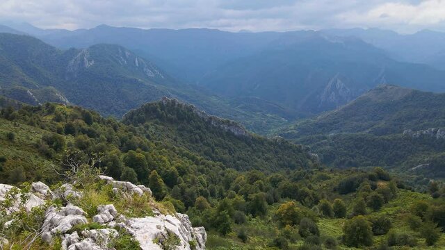 Dramatic aerial reveal of rocky mountainous outcrop, Redes Natural Park