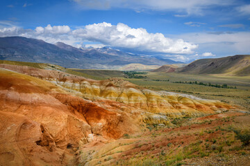 Amazing natural phenomenon-Martian landscapes in the Altai mountains. Multicolored rocks against a blue sky with white clouds. Futuristic panoramic picture, background image. Mars.