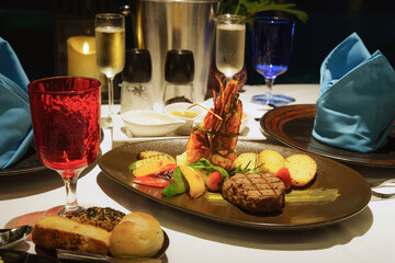 grilled beef and tiger prawn with roasted potatoes and grilled vegetables