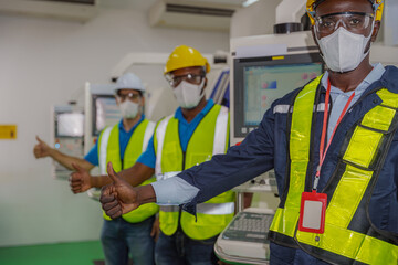 factory worker and team in uniform thumb up together for teamwork