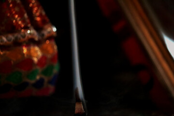 Incense stick smoke rising in a line