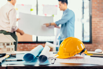 safety helmets  on the table at site construction. Architect, Engineer and businessman  read  planning background.