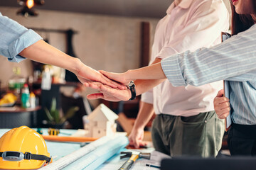 Obraz premium Engineer and architect partners team work join hands together. group people hands were collaboration to trust in business.