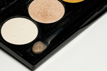 Close-up of eyeshadow palettes with brushes isolated on white background. Beauty industry and make-up products.