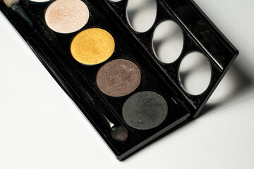 Close-up of eyeshadow palettes with brushes isolated on white background. Beauty industry and make-up products.