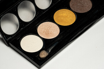 Close-up of eyeshadow palettes with brushes isolated on white background. Beauty industry and make-up products.