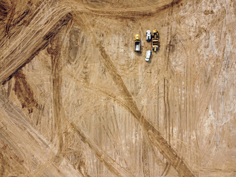 Aerial Shot Of Road Construction Equipment On An Open Field