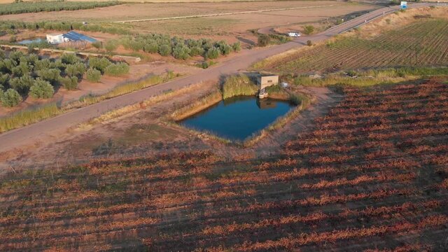 Aerial images approaching a water basin for irrigation of a vineyard in southern Spain