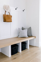 Modern mudroom with hat and leather bag