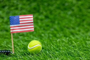 Tennis ball with Flag of America on green grass