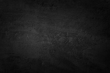 Close up retro plain dark black cement & concrete wall background texture for show or advertise or...