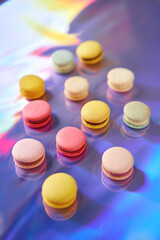 French cake macaron. Set of cute sweets on colorful rainbow background. almond cookies, pastel colors, top view