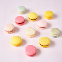 French cake macaron. Set of cute sweets on pastel pink background. almond cookies, pastel colors, top view