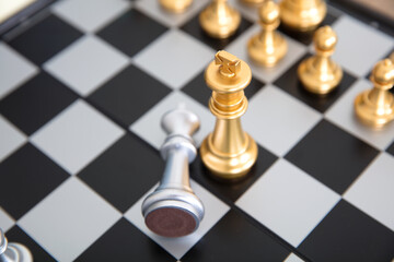 Chess pieces in a duel on a chess board