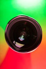 The camera lens and the beautiful multi-colored gradient color. Optics. Vertical photo